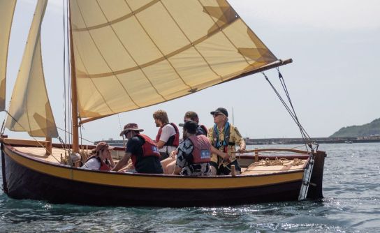 Graduates of the Boat Building Academy (BBA) joyously launch their new boats on hottest June day ever.