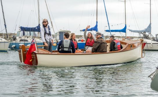 Boat Building Academy’s largest female cohort launch their boats in Lyme Regis